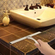 Moisture is the enemy of bathrooms, and a squeegee will push large amounts of it towards a drain where it belongs.